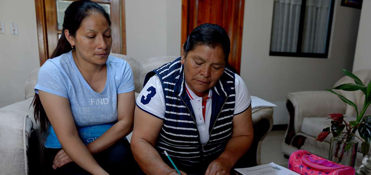 Mar&iacute;a Pullataxi (der.) usa un disco compacto para seguir las clases desde la casa (Quito). El programa estatal de escolarizaci&oacute;n utiliza el sistema de preparaci&oacute;n radiof&oacute;nica. 