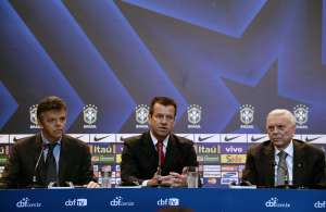 Dunga (c.) habla con los medios en su presentaci&oacute;n como entrenador de la selecci&oacute;n brasile&ntilde;a, junto a &eacute;l est&aacute;n Jose Mar&iacute;a Mar&iacute;n (d.), presidente de la CBF, y Guilherme Rinaldi. Foto: AFP