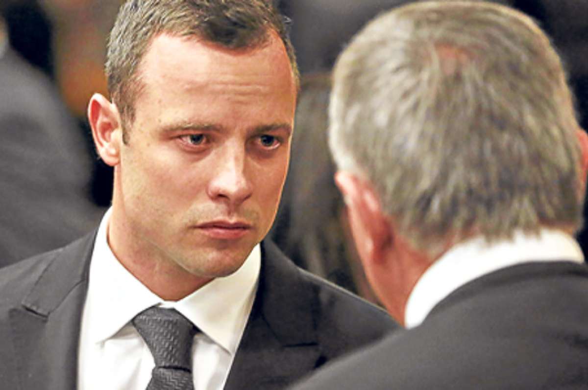 Pistorius (izq) dialoga con su abogado, Barry Roux, durante una de las &uacute;ltimas audiencias en Pretoria. Foto: AFP.