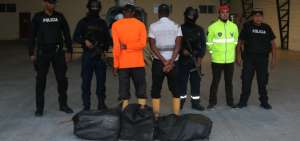 Los agentes muestran a los detenidos y a la carga incautada.