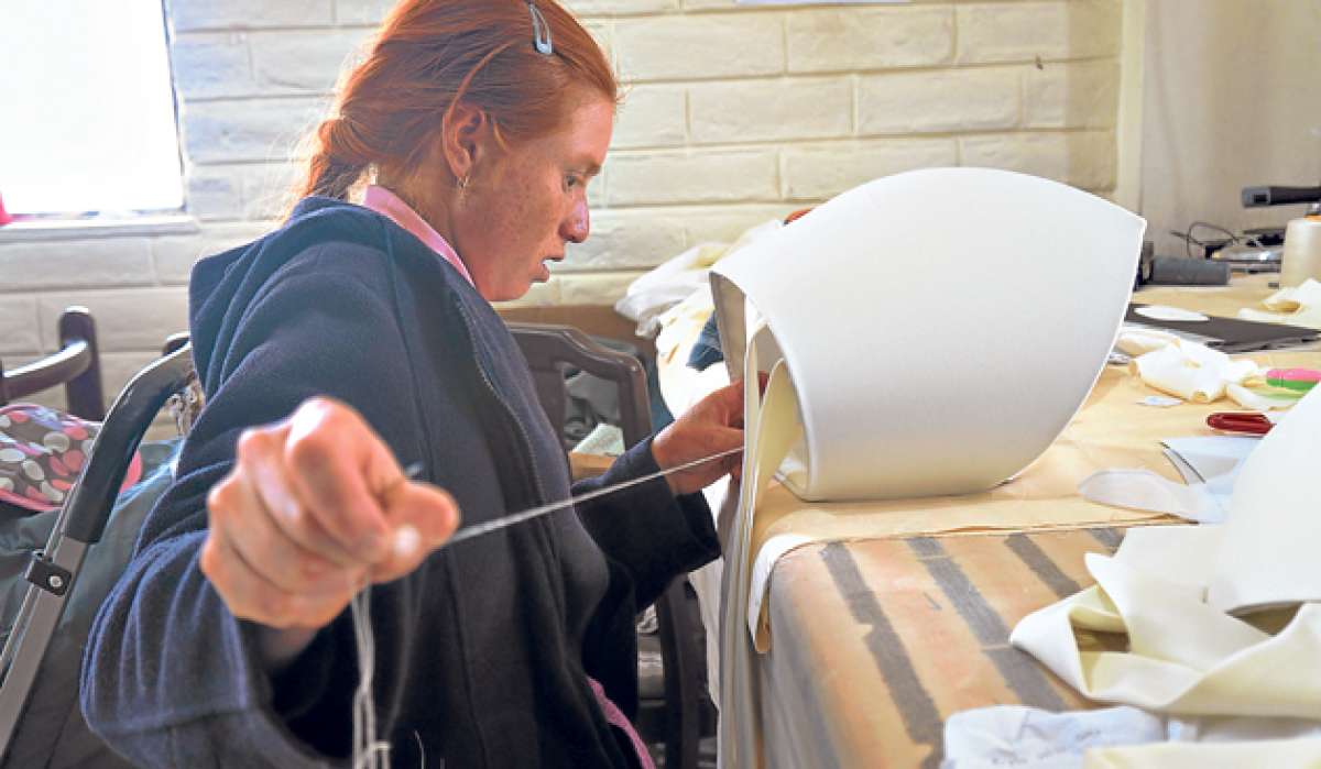Una de las j&oacute;venes religiosas cose a mano una de las 100 mitras que lucir&aacute;n los sacerdotes. Foto: Silvia Osorio/El Tel&eacute;grafo