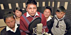 Abel Lligalo (poncho rojo), Gina Capuz, Inti Chicaiza y otros se hallan en una cabina de grabaci&oacute;n. Foto: Roberto Ch&aacute;vez / El Tel&eacute;grafo