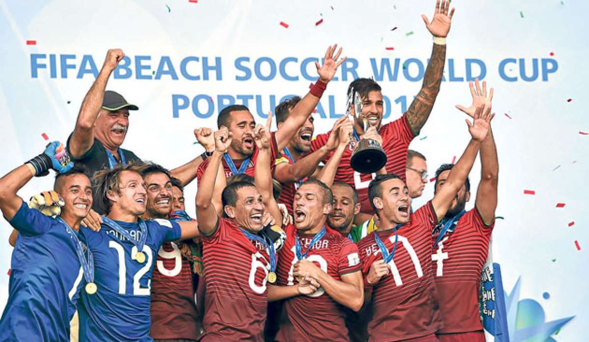 Los jugadores portugueses festejan el t&iacute;tulo mundial despu&eacute;s de recibir el trofeo durante la ceremonia de premiaci&oacute;n en la playa Espinho. Foto: AFP