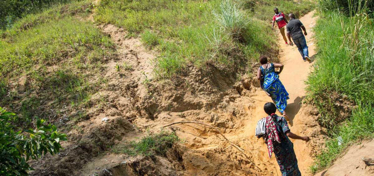 Un grupo de habitantes sube una colina erosionada, donde se encuentra el Centro Regional de Investigaci&oacute;n Nuclear de Kinshasa (CREN-K). 
