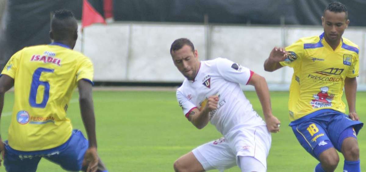 Brahian Alem&aacute;n disputa el bal&oacute;n ante dos jugadores de Delf&iacute;n. 