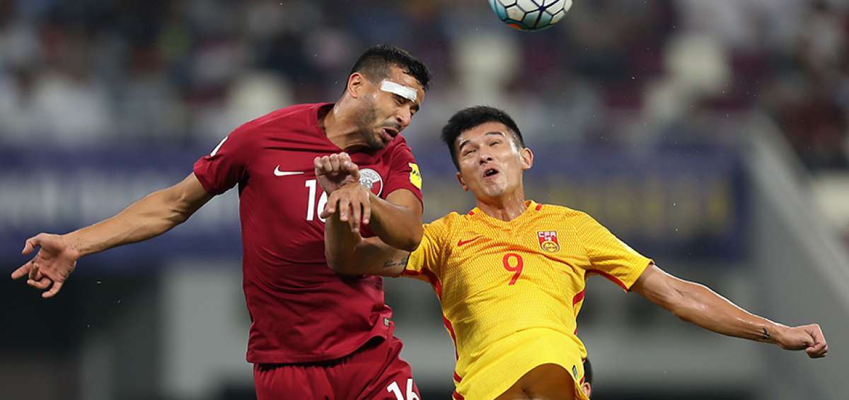 El delantero chino Mao Jianqing (d) disputa el bal&oacute;n con un defensa de Catar, en el partido del martes pasado. 