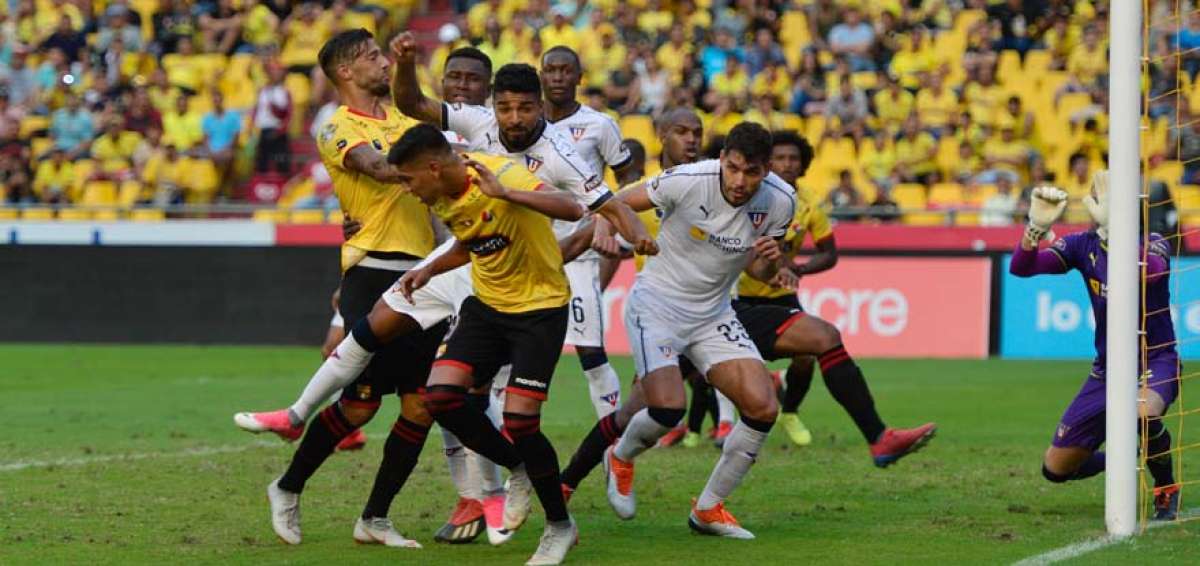 El jugador de Liga de Quito Rodrigo Aguirre (c) disputa un bal&oacute;n a&eacute;reo con los defensas de Barcelona, durante el partido disputado la tarde de este s&aacute;bado 30 de marzo en el estadio Monumental de Guayaquil.
