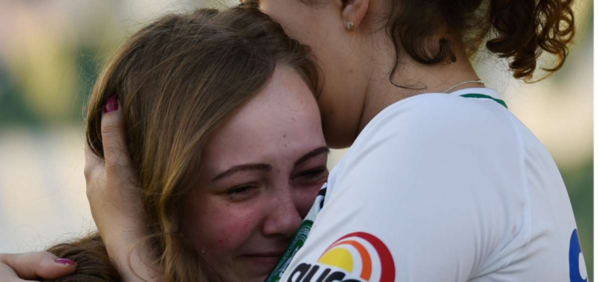 La esposa de uno de los futbolistas que falleci&oacute; en el accidente es consolada por una hincha del Chapecoense, mientras esperaban la llegada de los cuerpos.