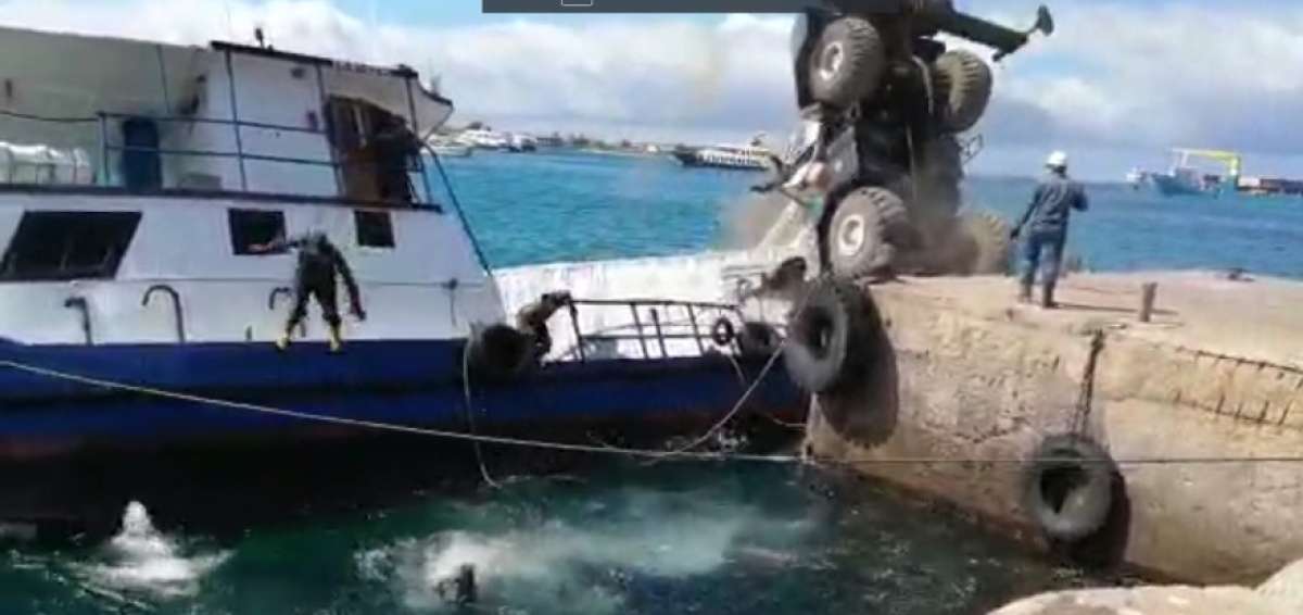 Momento de la maniobra de carga que deriva en el hundimiento de la gabarra, contenedor y gr&uacute;a.