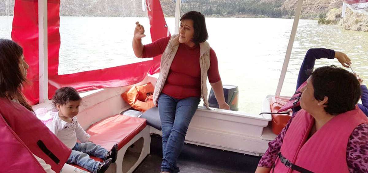 La gu&iacute;a Lilia Altamirano indica las zonas en donde anidan las aves en los entornos de la laguna de Yambo. Los turistas que la escuchan llegaron desde Tulc&aacute;n. 