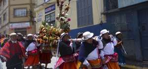Las mujeres llevan en hombros el cuy-&ntilde;a&ntilde;a. Se trata de un altar con frutas, granos tiernos, cuyes y gallinas.