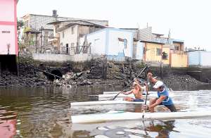 Daniel Le&oacute;n, Ernesto Rojas, Stefany Perdomo y Darwin Chonillo realizan un &lsquo;sprint&rsquo; mientras pasan por una cloaca que arroja desechos residuales al Estero Salado, a la altura de la calle Guerrero Mart&iacute;nez. Foto: Karly Torres / El Tel&eacute;grafo
