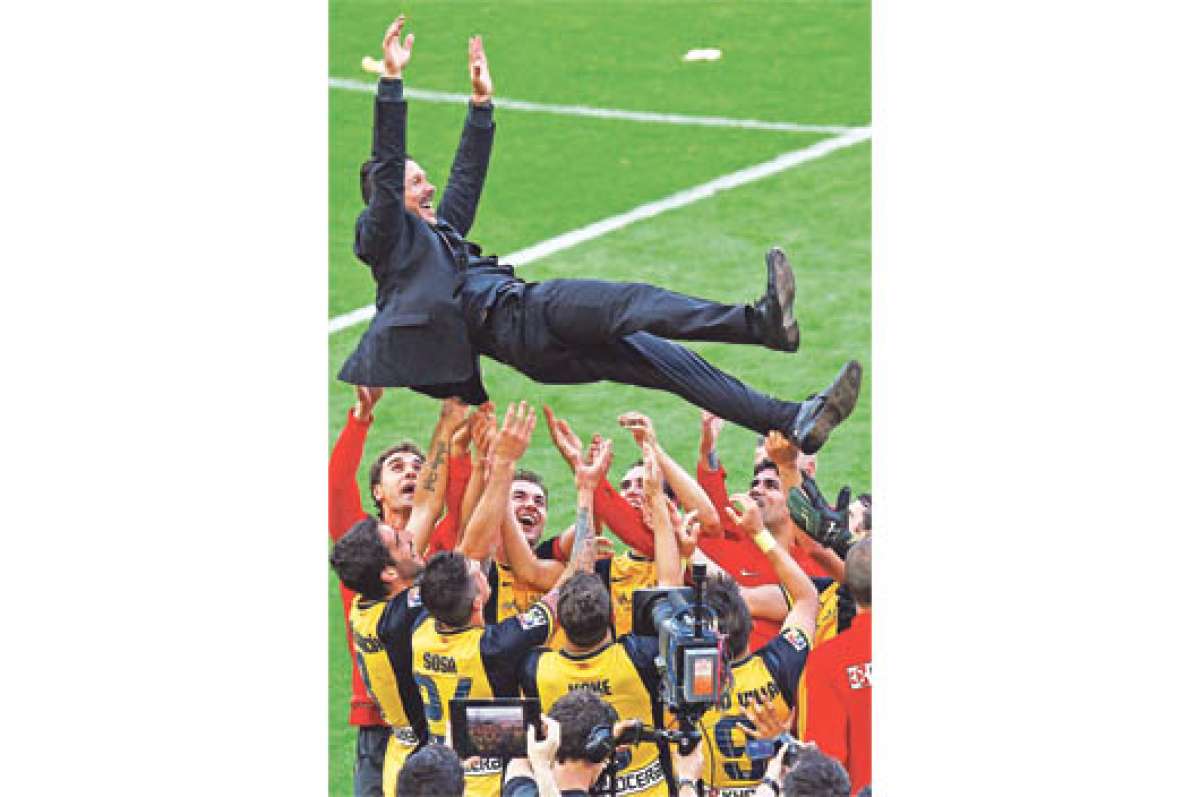 La plantilla del Atl&eacute;tico de Madrid levanta al entrenador Diego Simeone luego de empatar ante el Bar&ccedil;a en la &uacute;ltima fecha de la liga. Foto: AFP