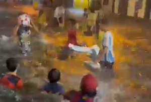Niñas y niños jugaron en una calle inundada por la lluvia en Guayaquil