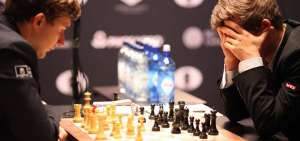 Carlsen se tapa la cara y calcula jugadas mientras Karjakin espera a que mueva. La cuarta partida dur&oacute; seis horas y media y casi lleg&oacute; a las 100 jugadas.
