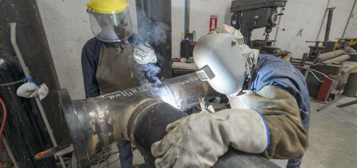 En el taller de la empresa Conspeccime, ubicado al nororiente de Quito, dos t&eacute;cnicos soldadores trabajan en una de las piezas requeridas por Petroamazonas.  