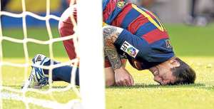 El jugador argentino Lionel Messi se queja sobre el c&eacute;sped del Camp Nou, luego de chocar con Pedro Bigas, defensa de Las Palmas. AFP