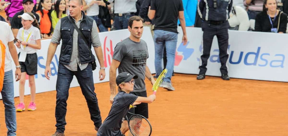 El n&uacute;mero tres del ranking ATP junto a uno de los afortunados que pudieron jugar un momento con el suizo.
