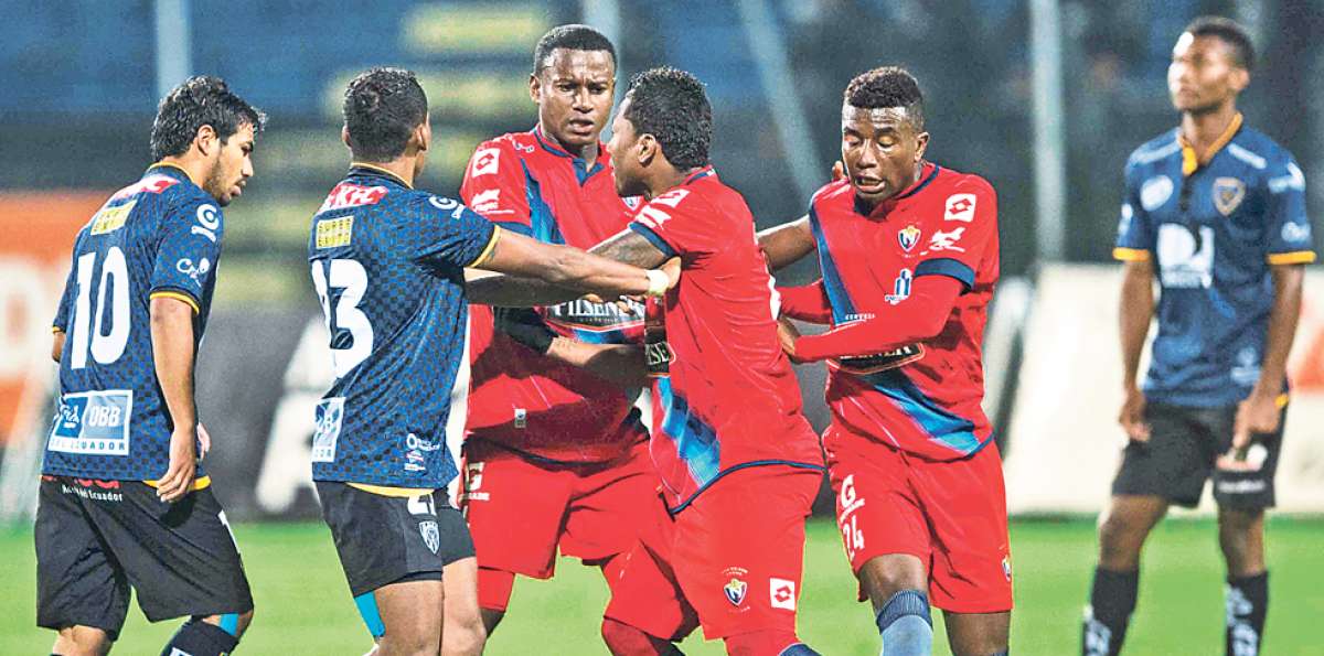 Junior Sornoza (izq.) y Fernando Guerrero forcejean con jugadores de El Nacional en el partido del s&aacute;bado. Foto: Marco Salgado.