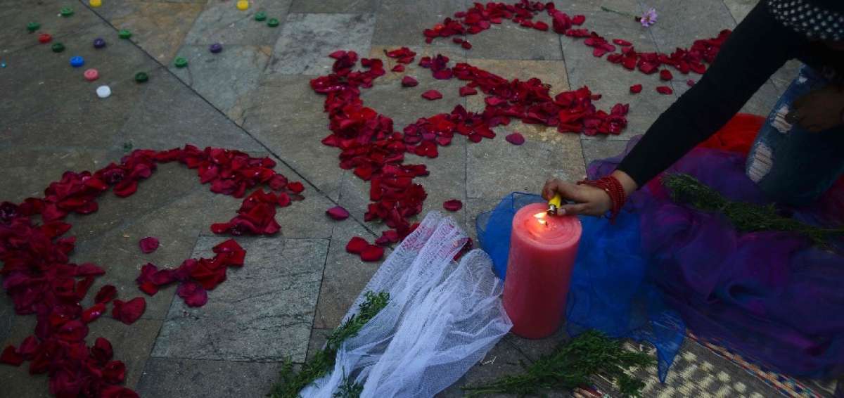 Una colombiana enciende una vela por la paz en la plaza Botero de Medell&iacute;n, en Antioquia.