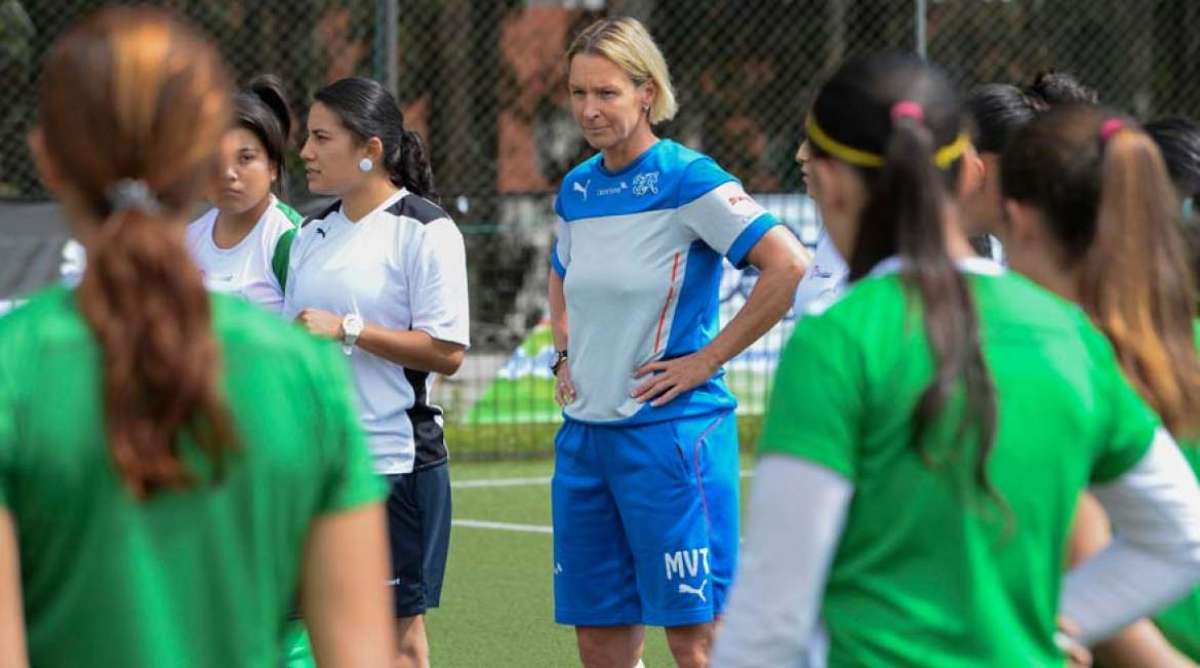La entrenadora Martina Voss-Tecklenburg da instrucciones junto a Mabel Velarde antes del entrenamiento.