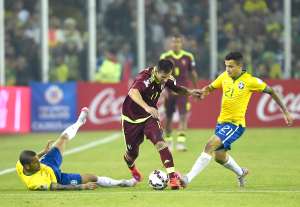 El volante venezolano C&eacute;sar Gonz&aacute;lez (c) intenta eludir la marca de los brasile&ntilde;os Dani Alves (i) y Philippe Coutinho (d), en el partido de ayer en Santiago. Foto: AFP