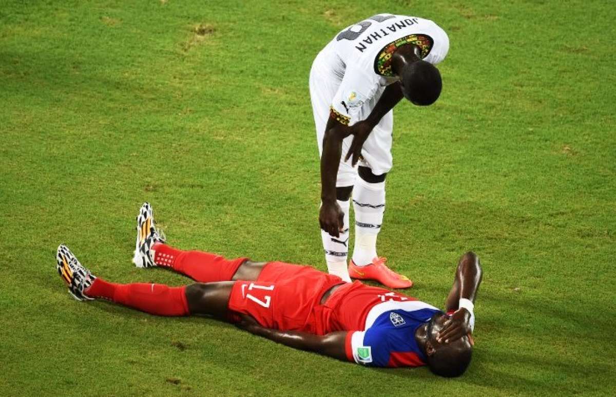 Uno de los zagueros de Ghana se preocupa por la situaci&oacute;n de su rival Jozy Altidore de Estados Unidos. Foto: AFP
